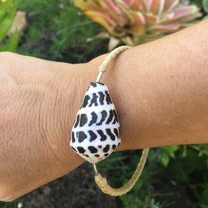 Shell and metal bracelet with handwoven lauhala.